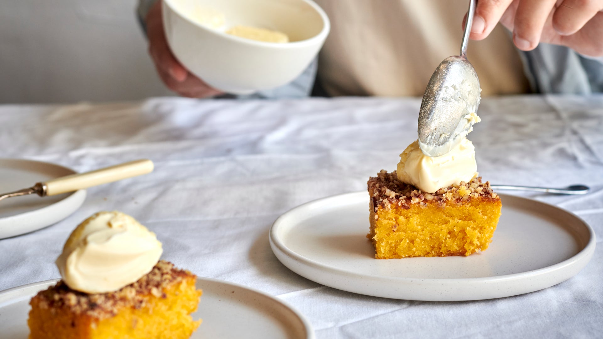 The Exploding Bakery Orange Polenta & Pecan cake being enjoyed with clotted cream.