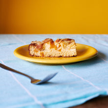 A slice of Peach, Ricotta & Almond Cake on a plate.
