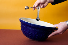 Someone measuring in porcelain bowl 