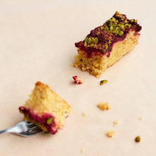 Sour Cherry & Pistachio cake portion with fork. Wholesale.